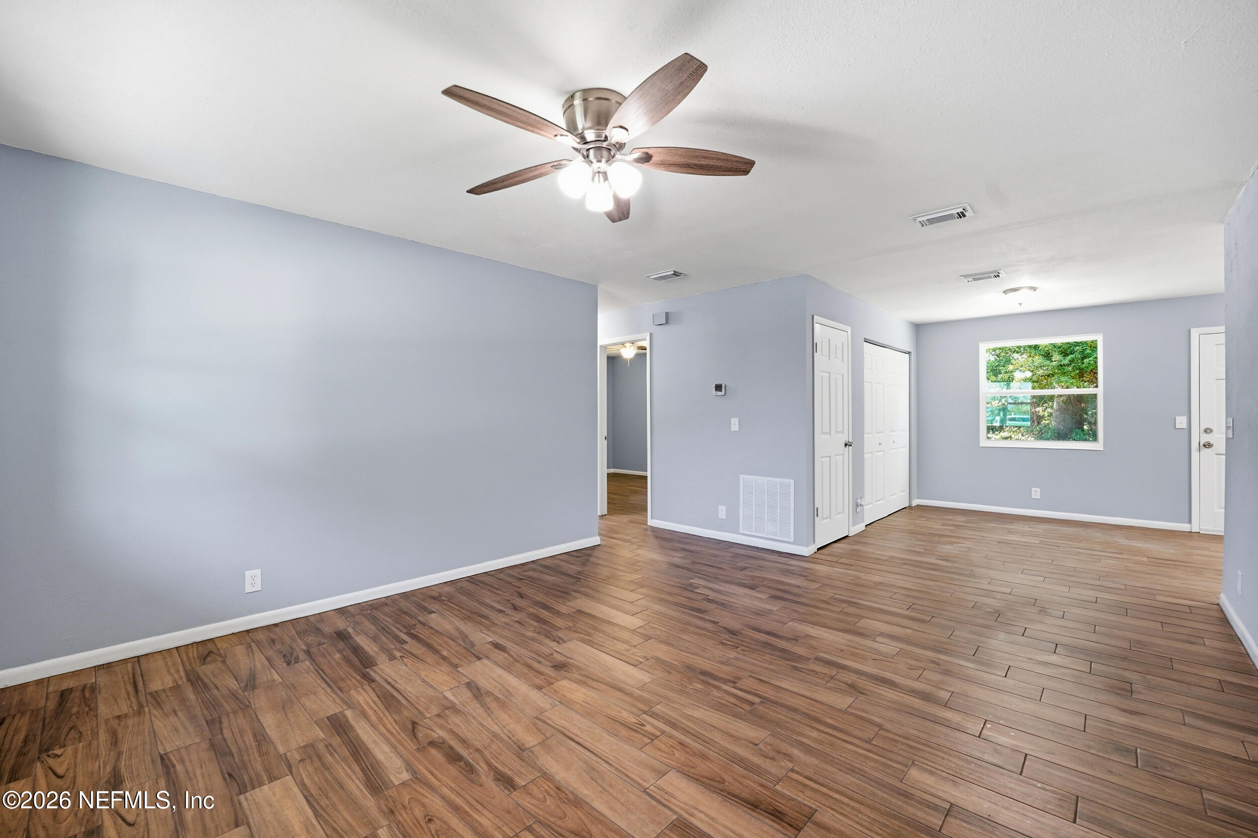 3084 Parental Home Road Jacksonville, FL 32216 - Photo 3 of 31 wooden floor in an empty room with a window