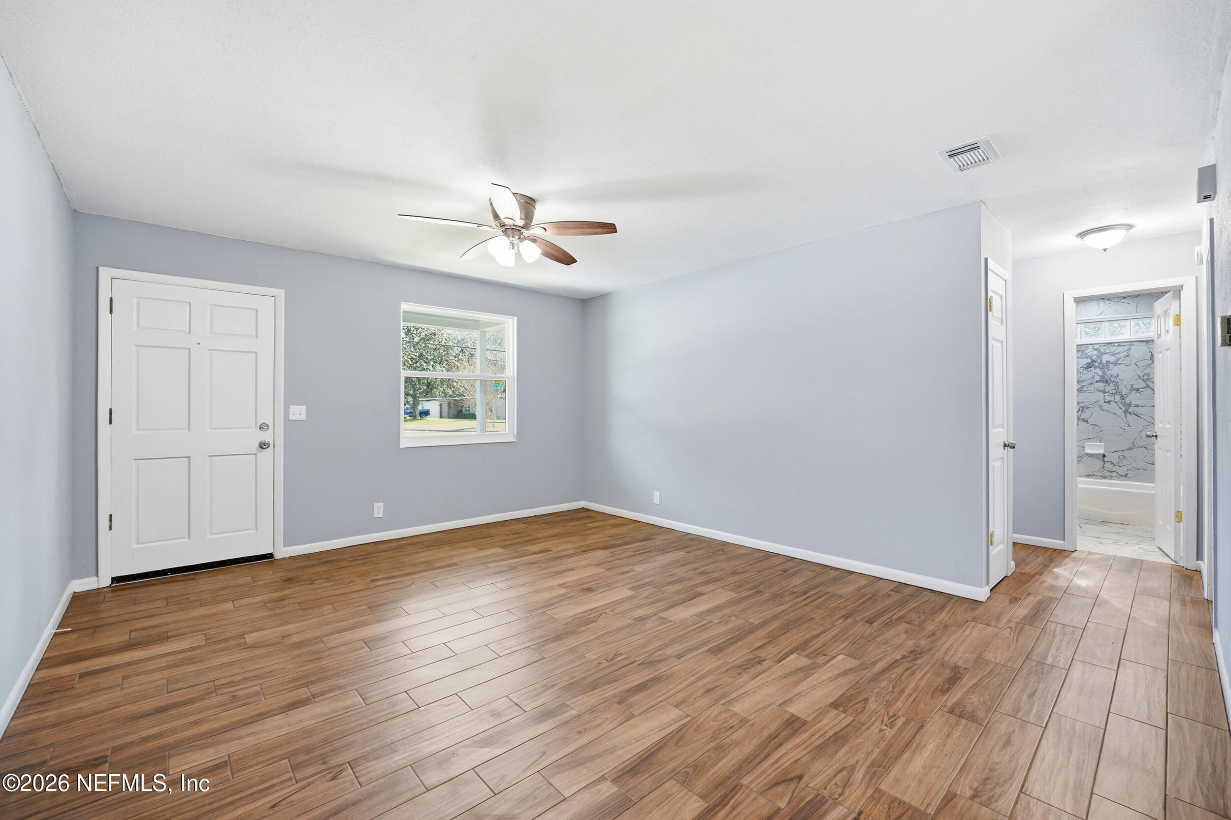 3084 Parental Home Road Jacksonville, FL 32216 - Photo 7 of 31 wooden floor in an empty room with a window