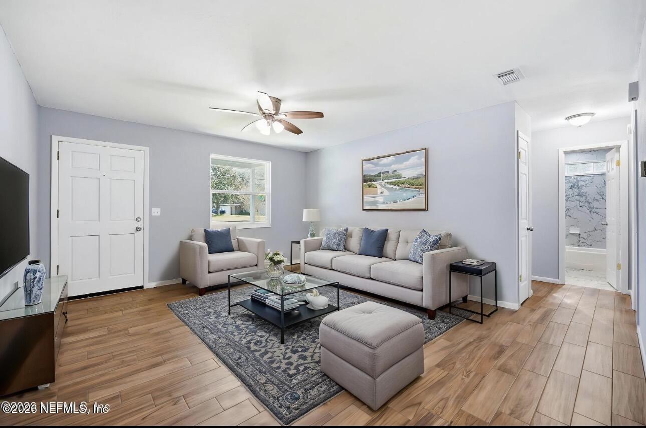 3084 Parental Home Road Jacksonville, FL 32216 - Photo 8 of 31 a living room with furniture wooden floor and a flat screen tv