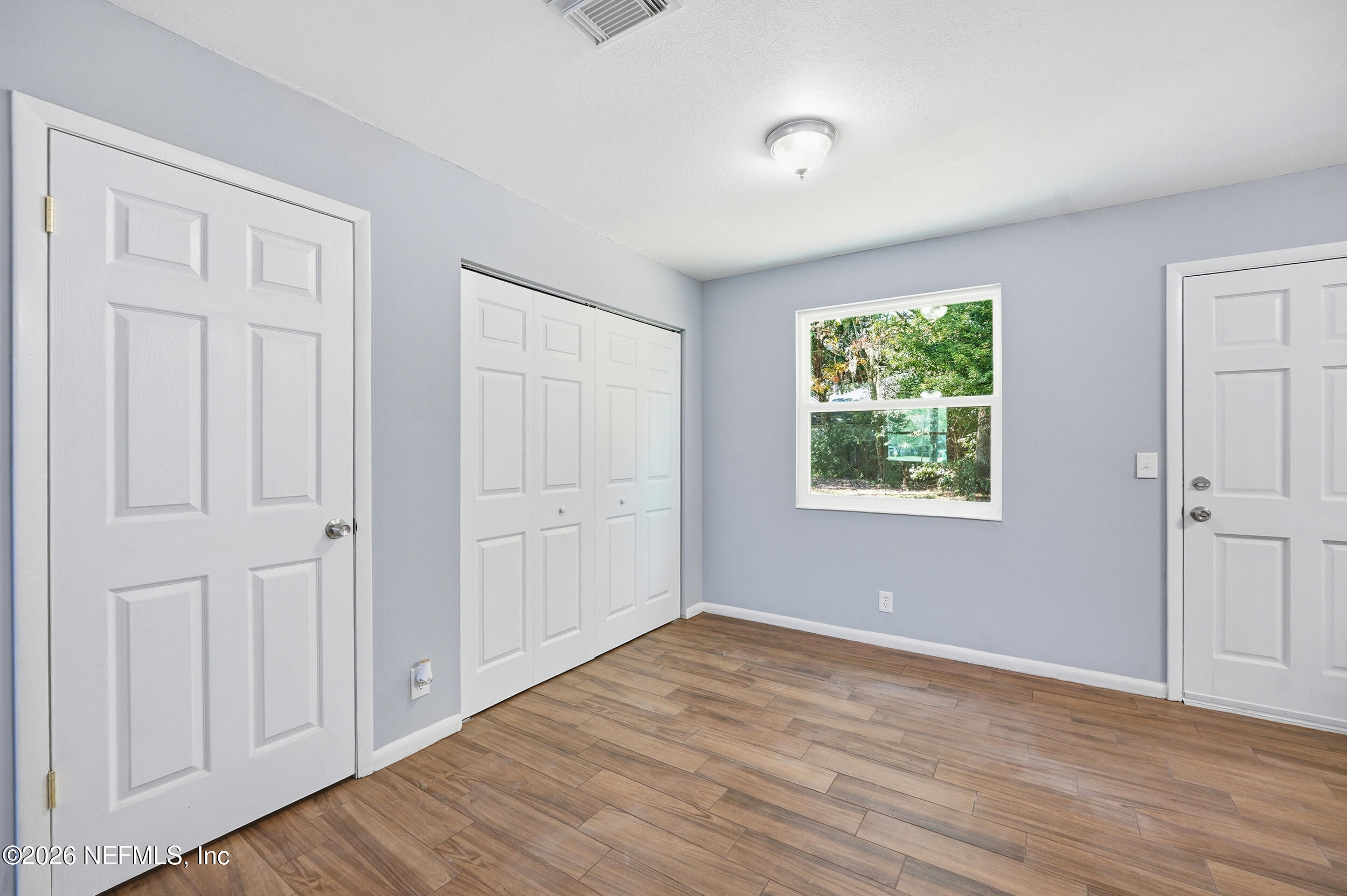 3084 Parental Home Road Jacksonville, FL 32216 - Photo 9 of 31 a view of an empty room with wooden floor and a window