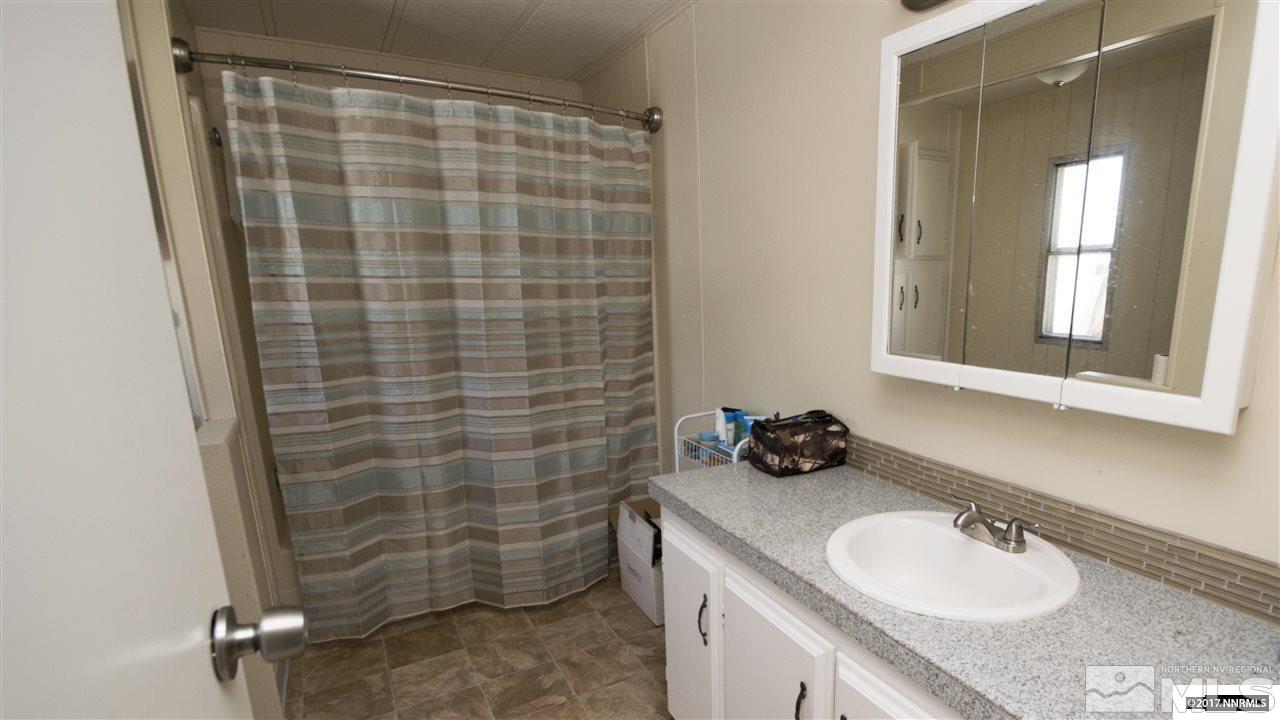 17795 Fantail Circle Reno, NV 89508 - Photo 4 of 10 a bathroom with a sink a toilet and shower