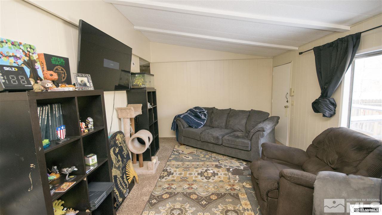 17795 Fantail Circle Reno, NV 89508 - Photo 5 of 10 a living room with furniture a fireplace and a flat screen tv