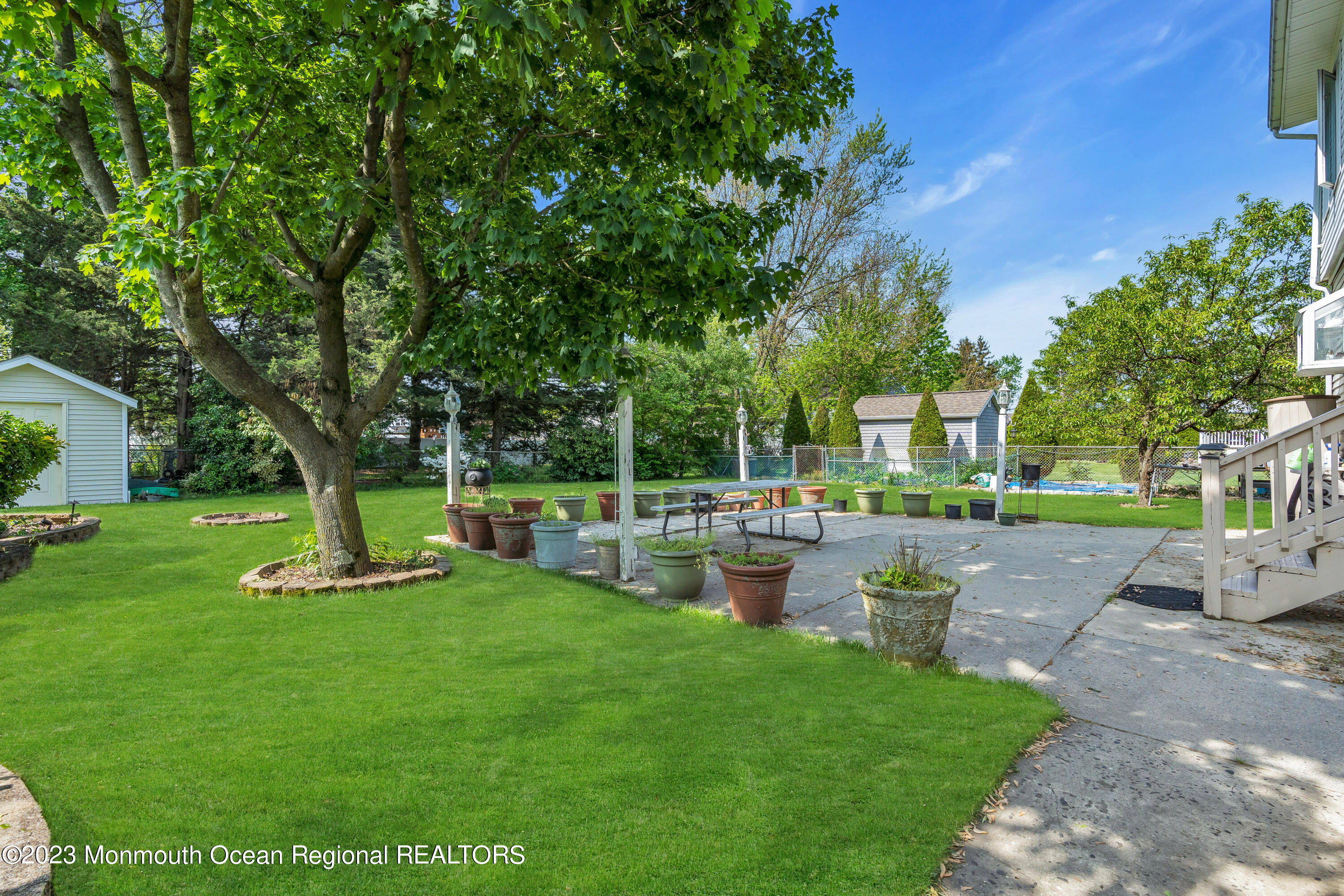 8 Willow Brook Road Freehold, NJ 07728 - Photo 11 of 49 a backyard of a house with fountain table and chairs