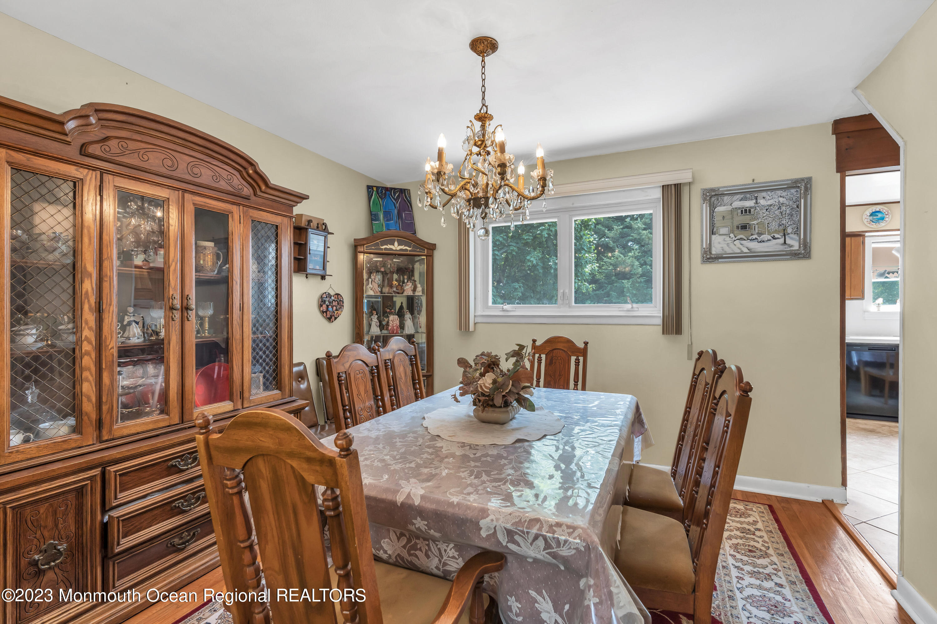 8 Willow Brook Road Freehold, NJ 07728 - Photo 22 of 49 a view of a dining room with furniture a chandelier and wooden floor