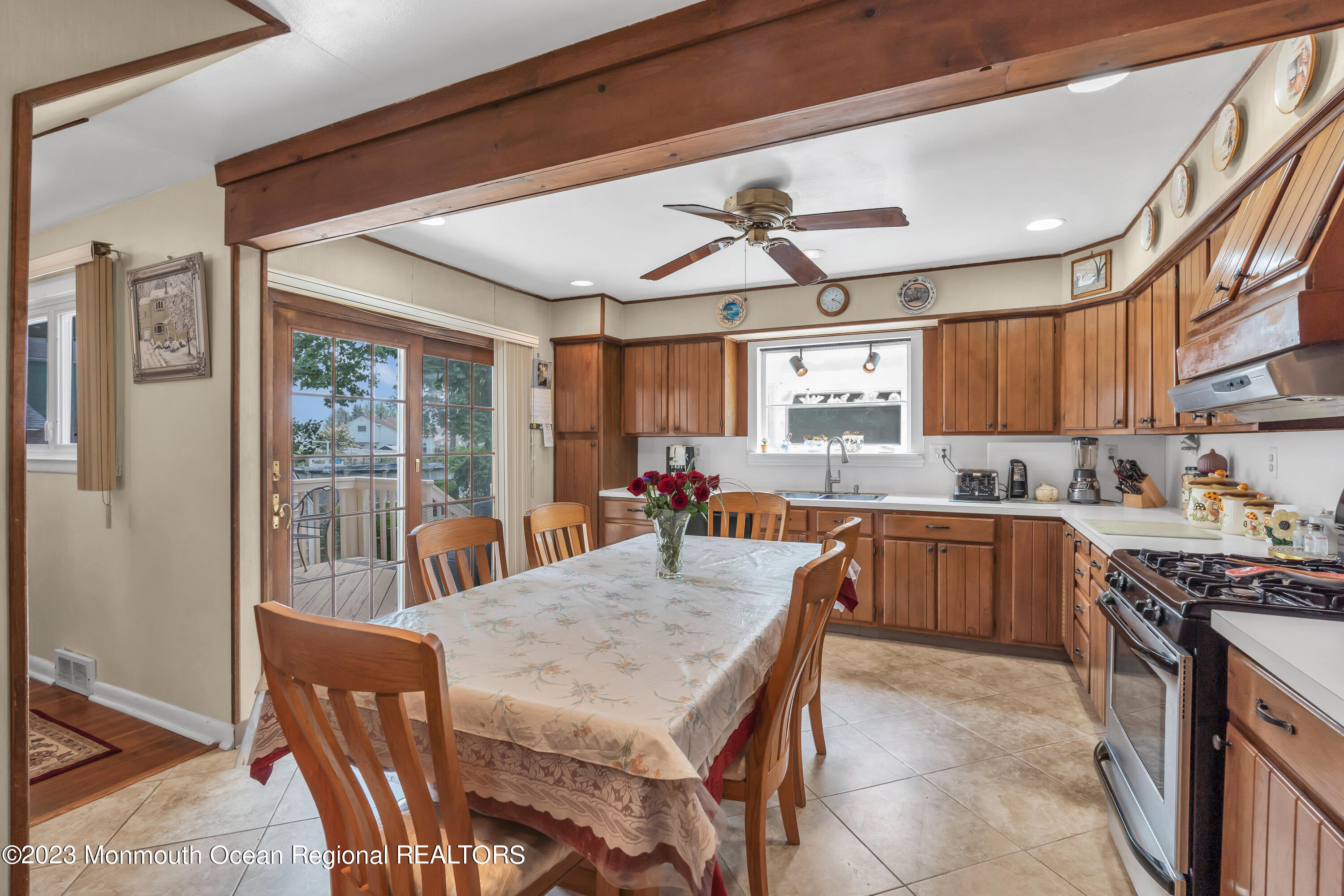 8 Willow Brook Road Freehold, NJ 07728 - Photo 26 of 49 a kitchen with stainless steel appliances granite countertop a stove a refrigerator a sink dishwasher a dining table and chairs with wooden floor