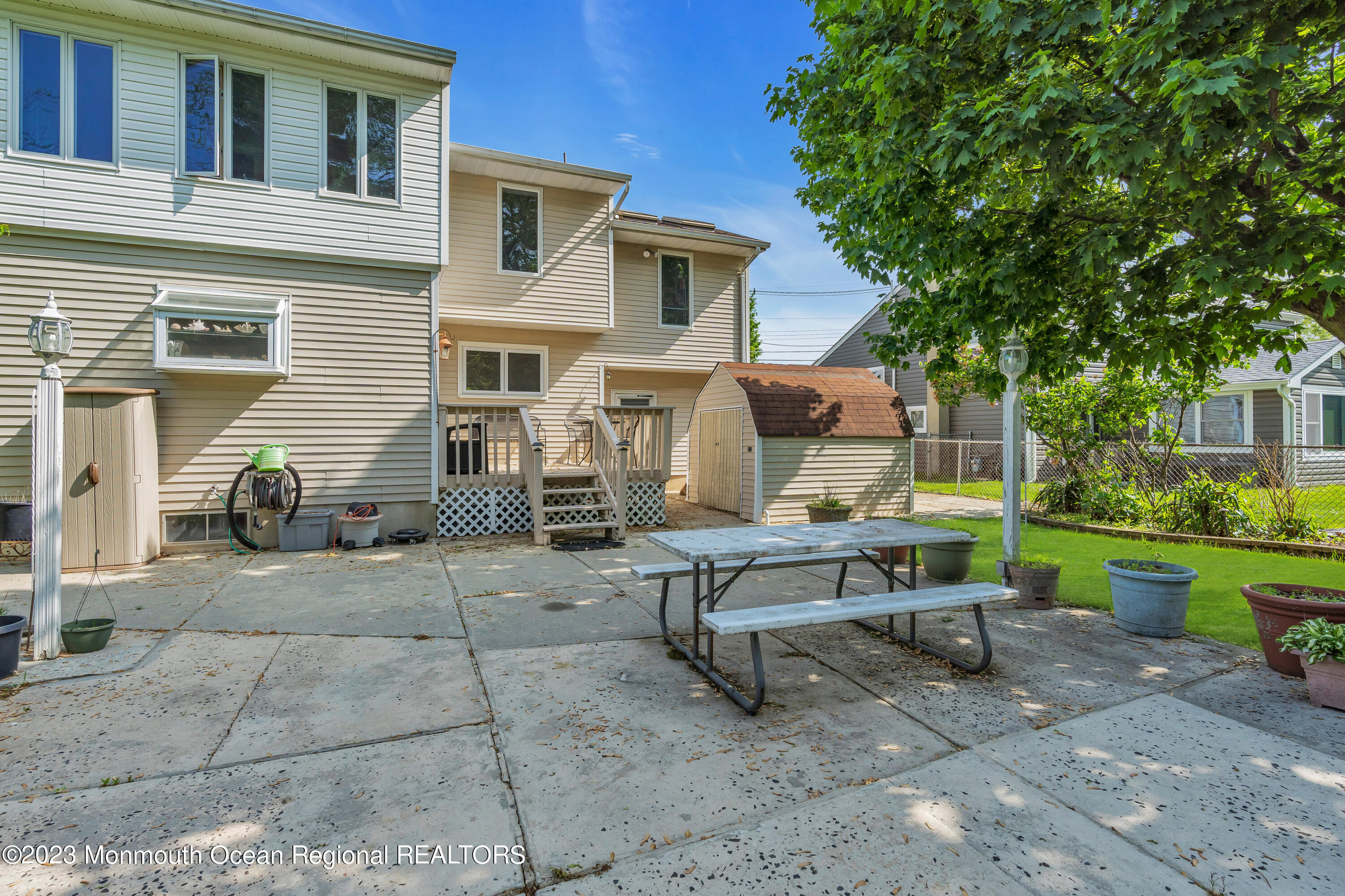 8 Willow Brook Road Freehold, NJ 07728 - Photo 8 of 49 a table and chairs sitting in front of a house