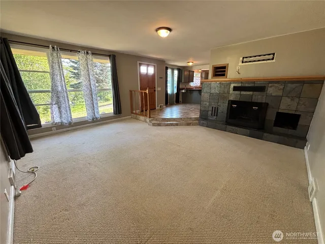 an empty room with furniture and a fireplace