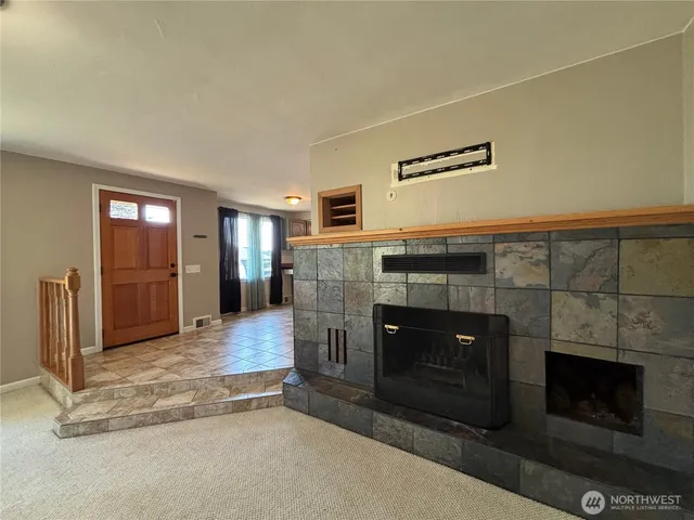 a view of a livingroom with furniture and a fireplace