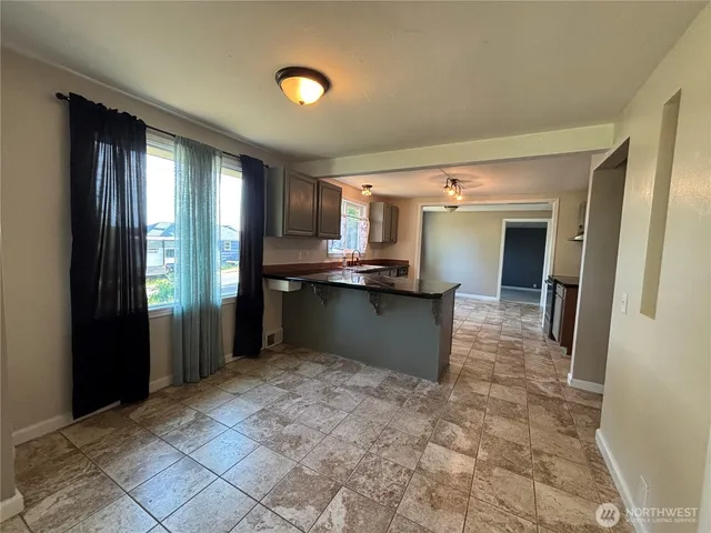 a view of kitchen with refrigerator cabinets and outdoor space