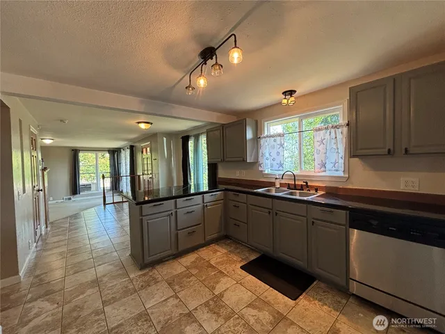 a large kitchen with kitchen island granite countertop a large counter top dining table and chairs