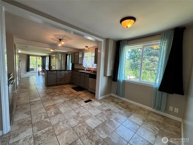 a view of a electric appliances and windows in a room