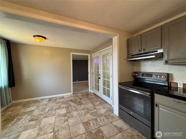 a kitchen with granite countertop a stove and a refrigerator