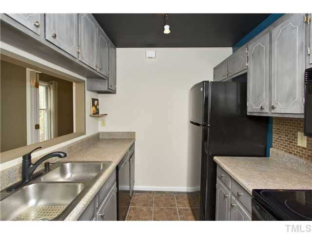 3205 Mill Run Raleigh, NC 27612 - Photo 11 of 22 a kitchen with stainless steel appliances granite countertop a sink a refrigerator and a granite counter tops