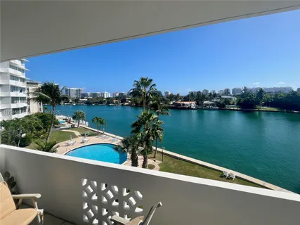 a view of a lake with couches and city view
