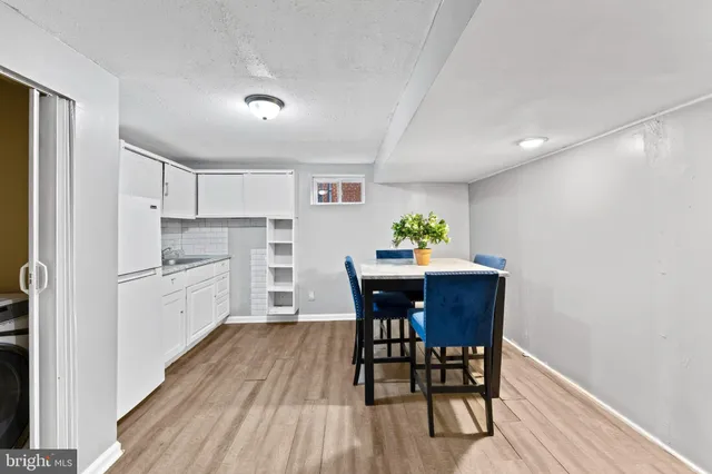 a kitchen with a table and chairs