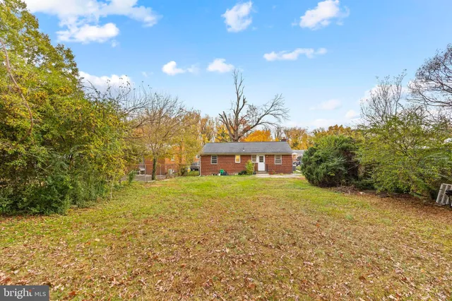 a yellow and red house with a yard
