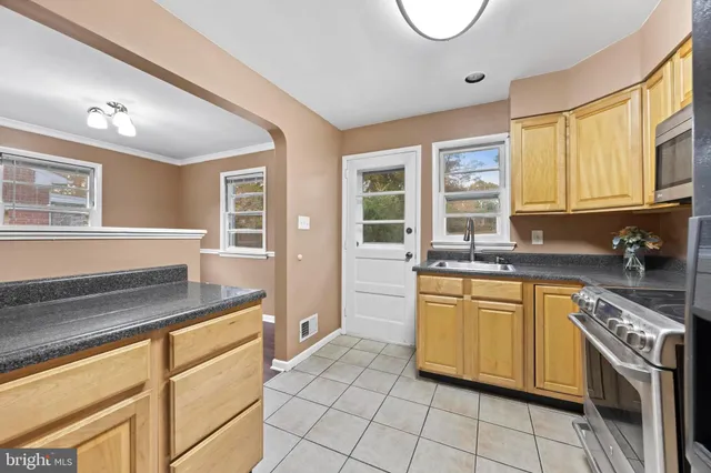a kitchen with stainless steel appliances granite countertop a sink and cabinets
