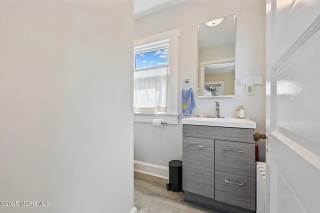 a bathroom with a sink vanity and mirror