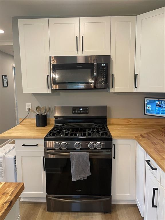 433 Spring Place Resaca Road Chatsworth, GA 30705 - Photo 13 of 51 a kitchen with stainless steel appliances granite countertop a stove a microwave and oven