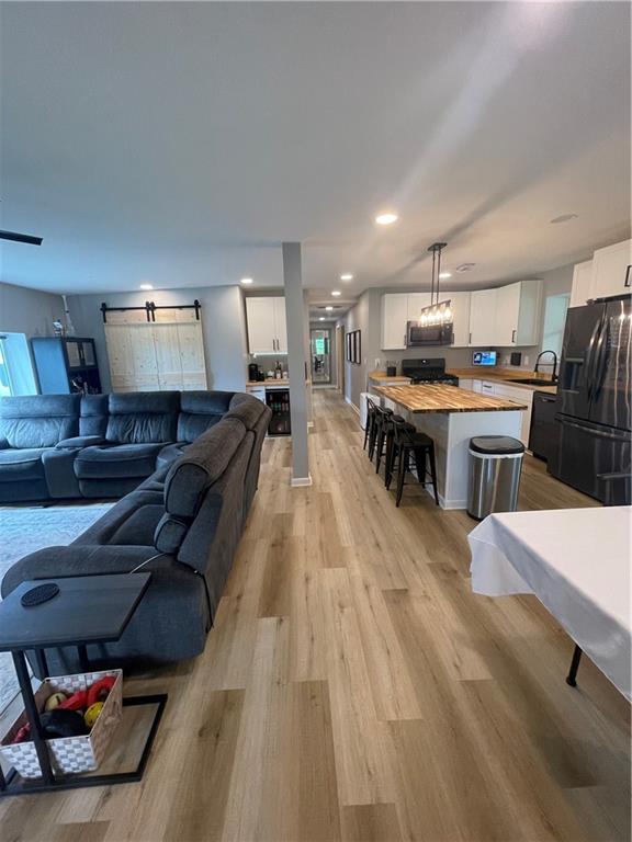 433 Spring Place Resaca Road Chatsworth, GA 30705 - Photo 18 of 51 a living room with furniture and a wooden floor