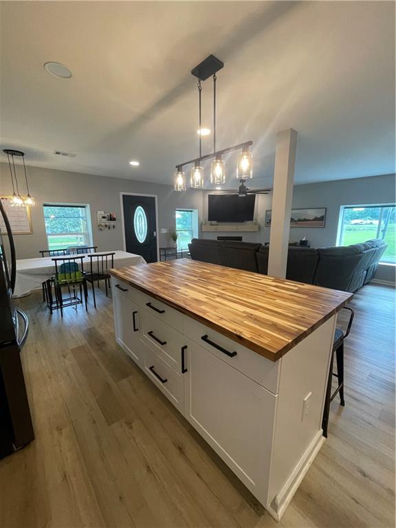 433 Spring Place Resaca Road Chatsworth, GA 30705 - Photo 4 of 51 a large kitchen with kitchen island a sink table and chairs