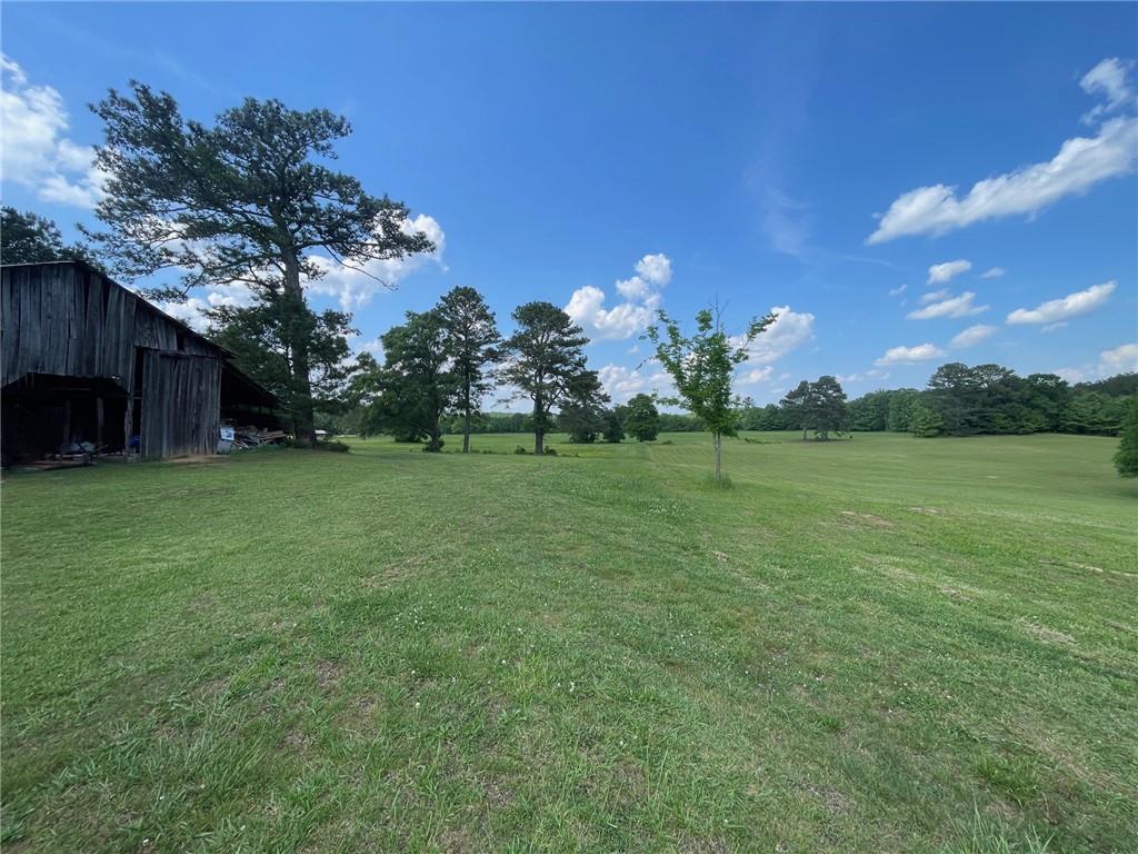 433 Spring Place Resaca Road Chatsworth, GA 30705 - Photo 50 of 51 a view of a garden with a building in the background