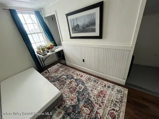 a view of a livingroom with wooden floor and a window