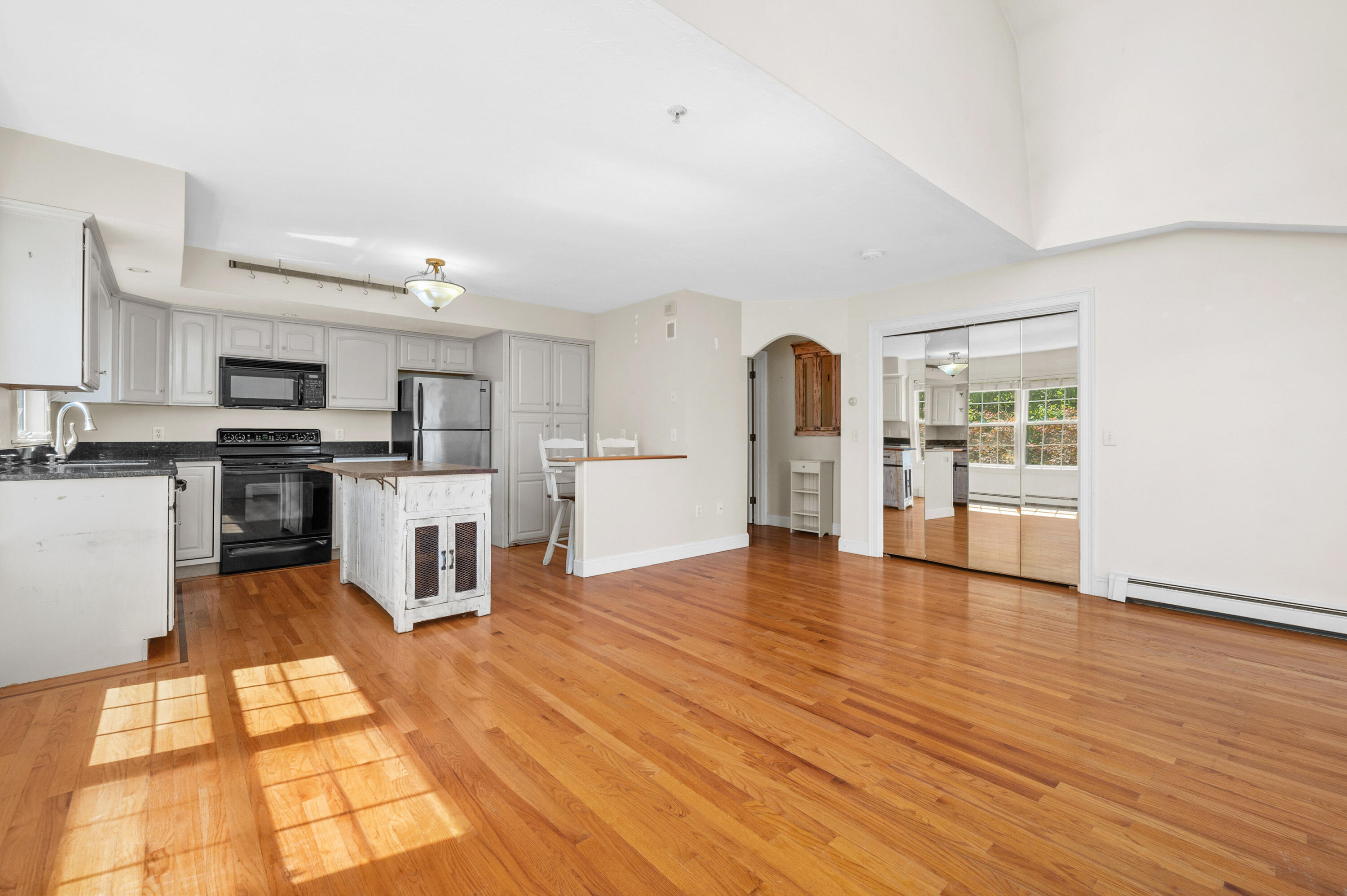 403 Lower County Road, Unit J Harwich Port, MA 02646 - Photo 11 of 26 a view of kitchen with microwave a refrigerator and cabinets