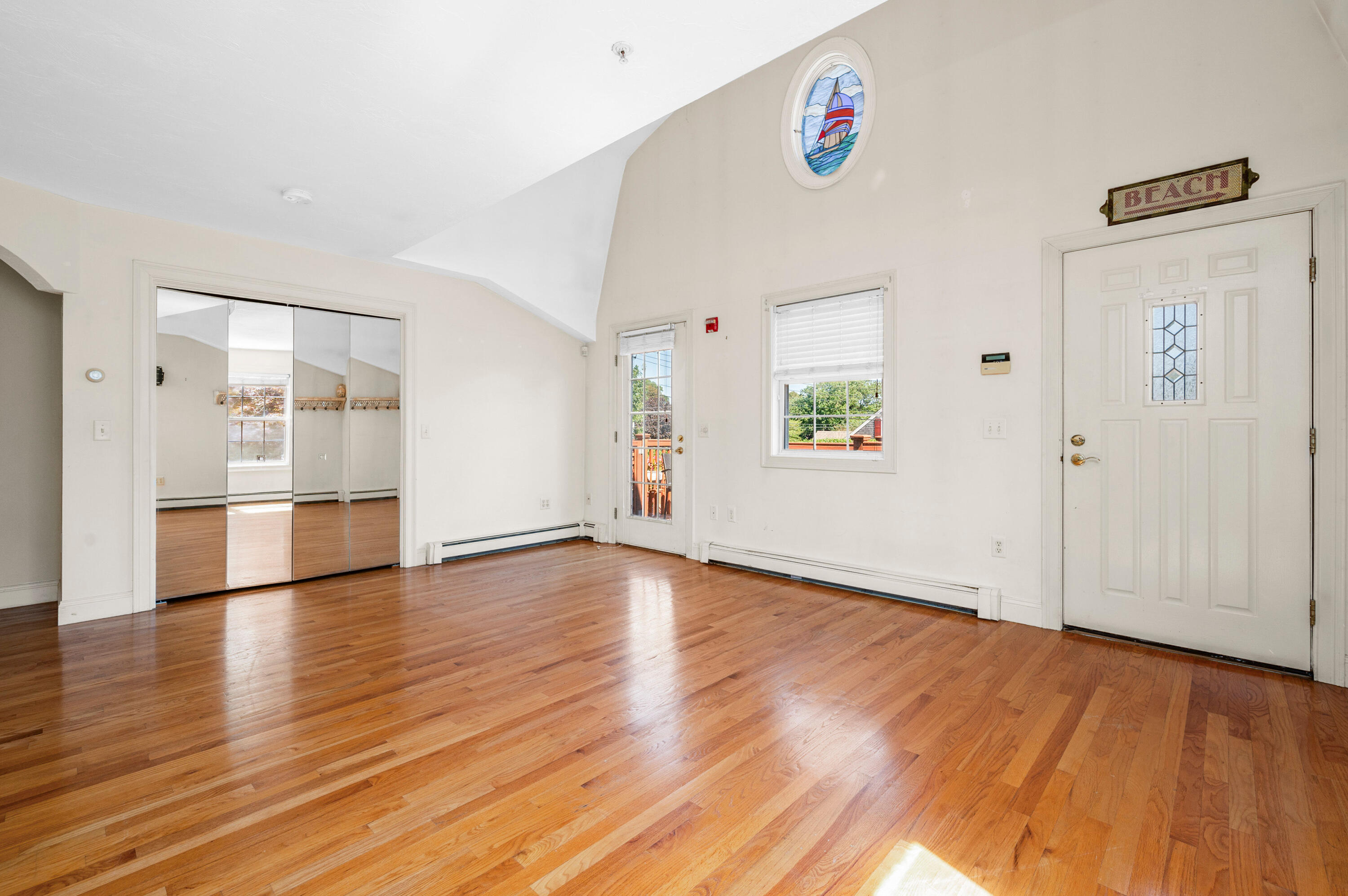 403 Lower County Road, Unit J Harwich Port, MA 02646 - Photo 17 of 26 a view of an empty room with wooden floor and windows