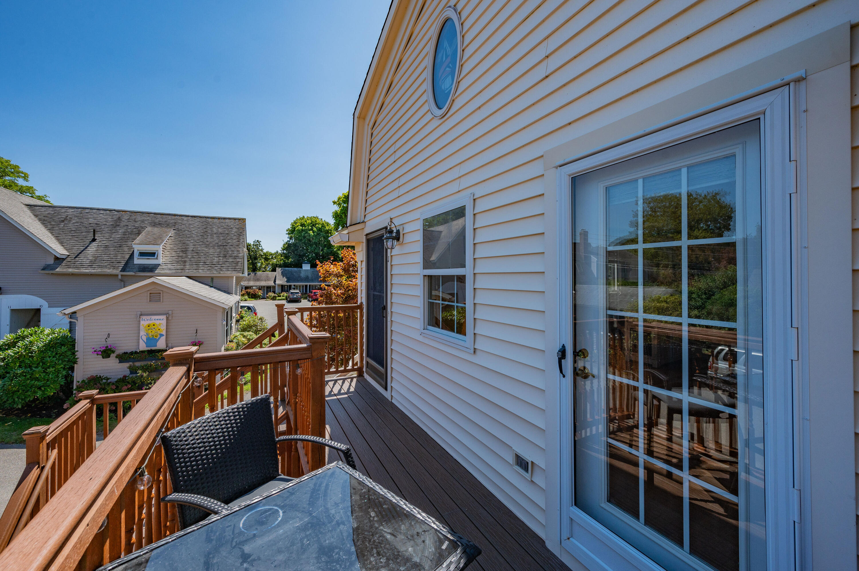 403 Lower County Road, Unit J Harwich Port, MA 02646 - Photo 24 of 26 a view of a deck with couches chairs with wooden floor