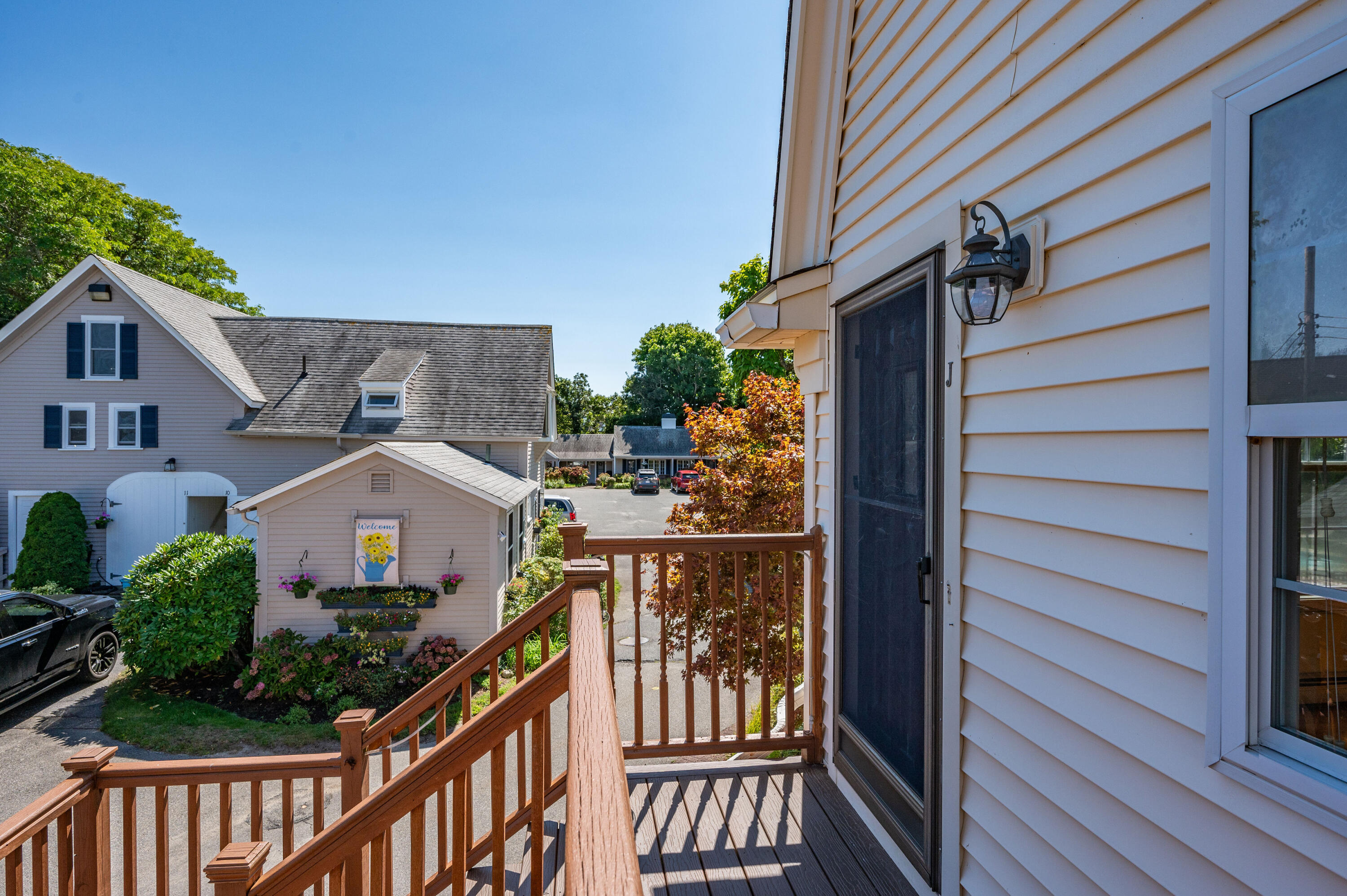 403 Lower County Road, Unit J Harwich Port, MA 02646 - Photo 26 of 26 a view of a house with wooden deck