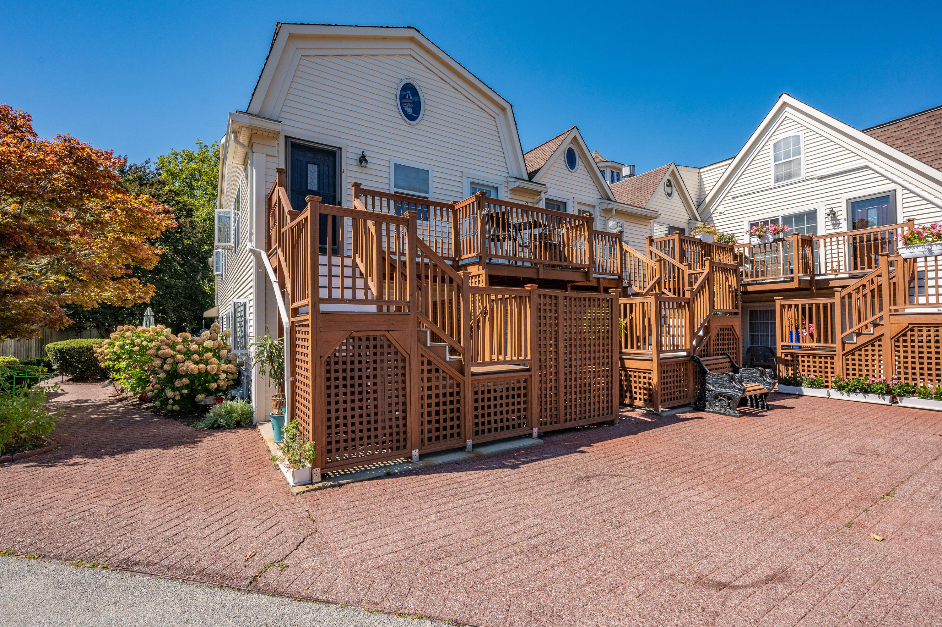 403 Lower County Road, Unit J Harwich Port, MA 02646 - Photo 7 of 26 a front view of a house with a yard