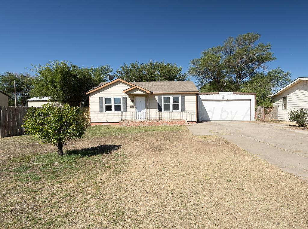a front view of a house with a garden and yard