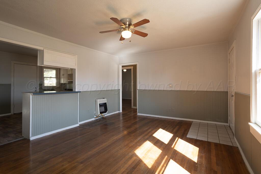 4422 South Ong Street Amarillo, TX 79110 - Photo 3 of 17 wooden floor in an empty room with a window