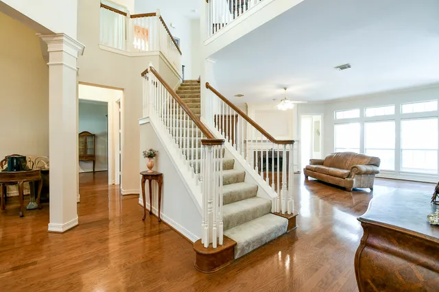 a view of entryway and hall with wooden floor
