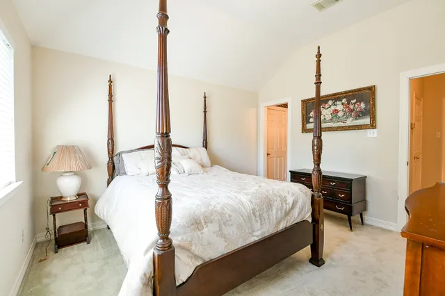 a bedroom with a bed window and chair