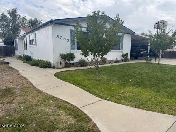 a front view of a house with a garden and plants
