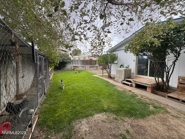 a view of a backyard with sitting area