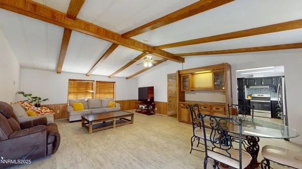 a living room with furniture a flat screen tv and outdoor seating