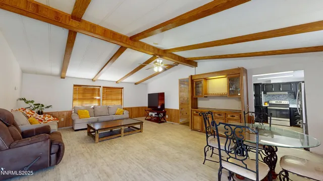 a living room with furniture a flat screen tv and outdoor seating