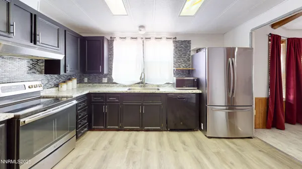 a kitchen with a refrigerator sink and cabinets