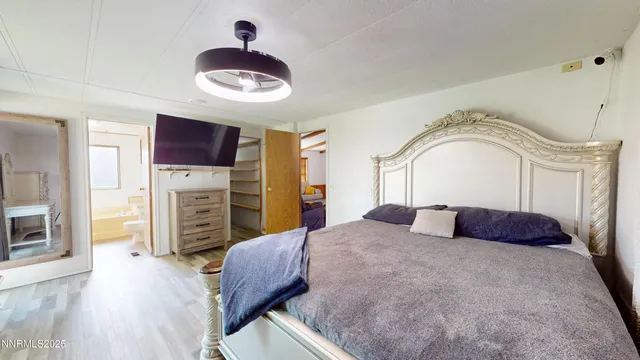 a bedroom with a bed and a television