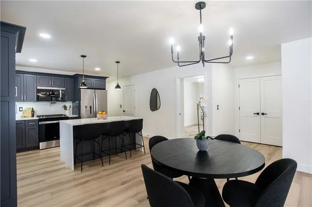 a large kitchen with a table and chairs