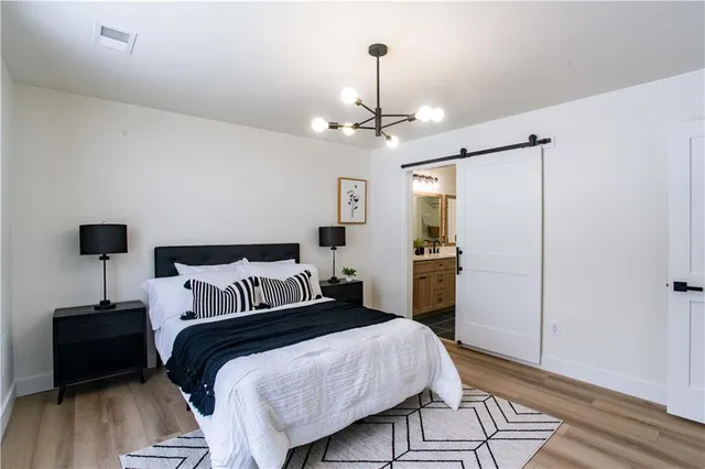 a bedroom with a bed and wooden floor