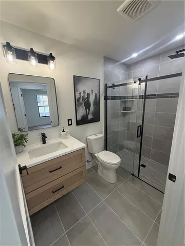 a bathroom with a toilet sink and shower