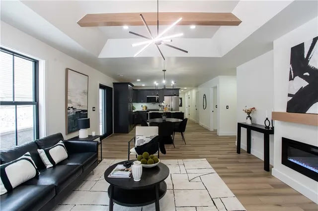 a living room with fireplace furniture and a chandelier