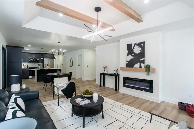 a living room with furniture a rug and a ceiling fan
