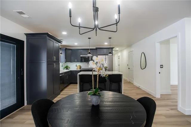a view of kitchen with stainless steel appliances granite countertop lots of counter top space