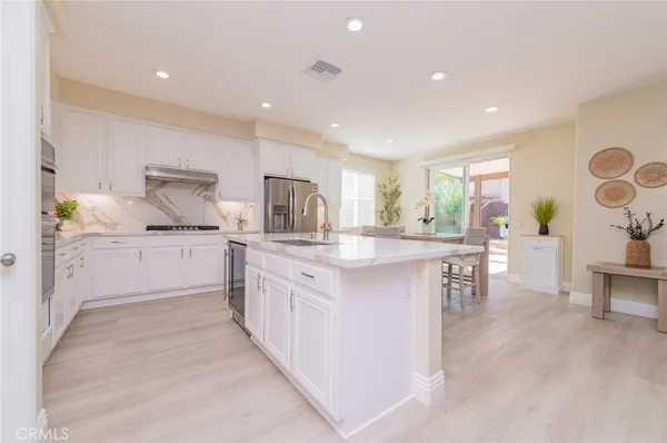 a dining room with furniture window and wooden floor
