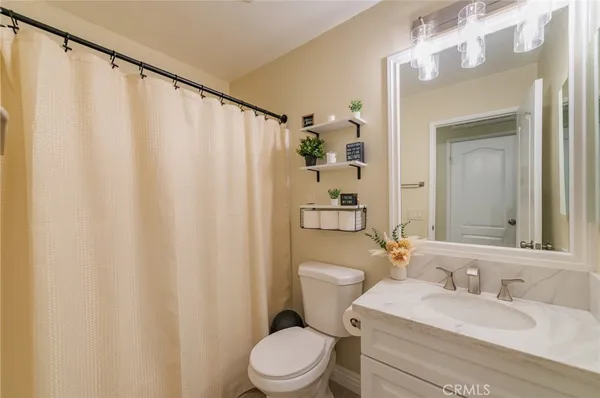 a white bath tub sitting in a bathroom and shower